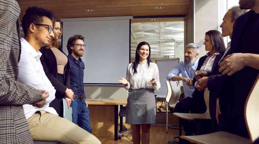 A photo of adult professionals gathering in a meeting.