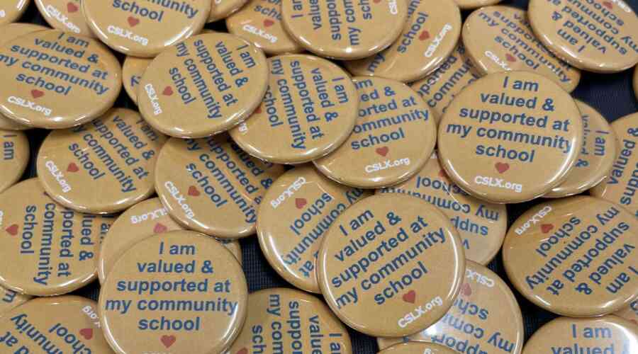 A pile of buttons that read, "I feel valued and supported at my community school."
