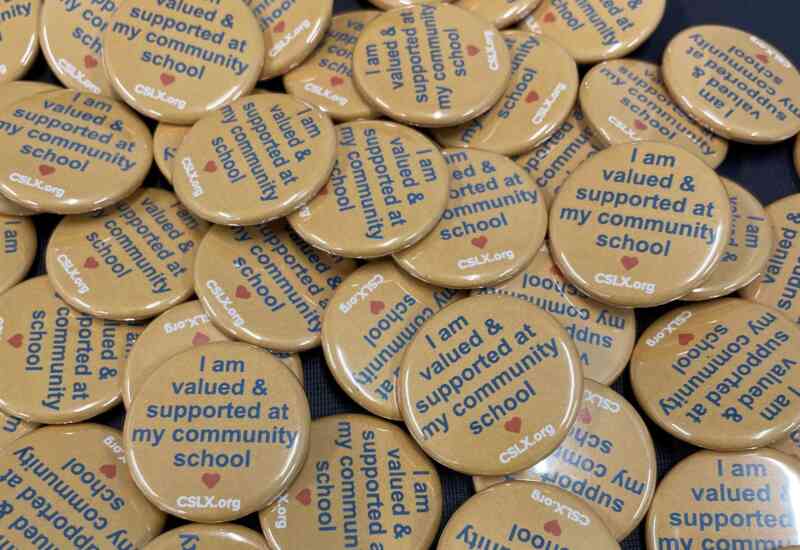 A pile of buttons that read, "I feel valued and supported at my community school."
