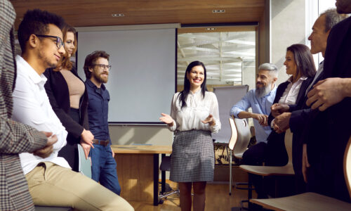 A photo of adult professionals gathering in a meeting.