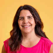 A headshot of Ali Metzler against a bright yellow backdrop.